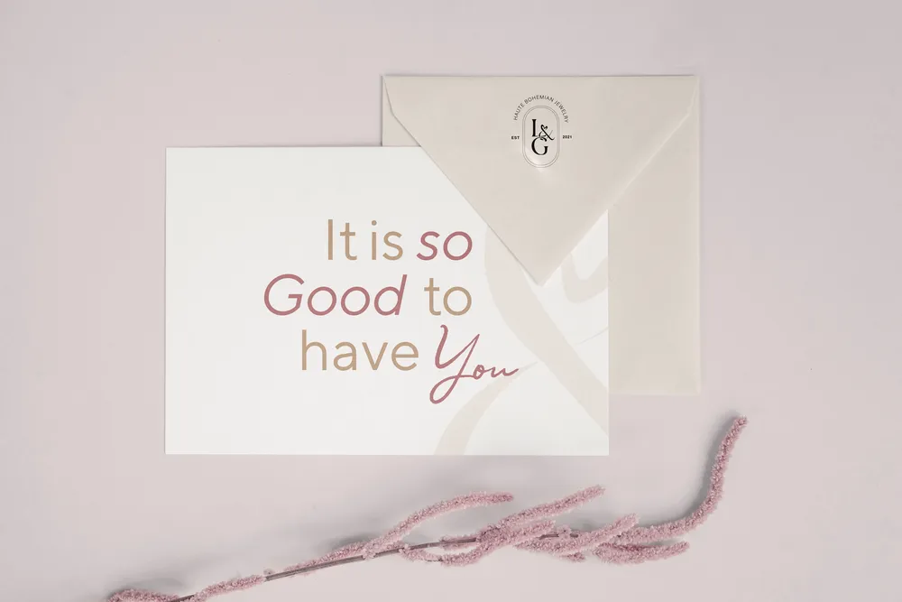 A Love & Grace note card reading “It is so good to have you”, on an envelope with the monogram seal.